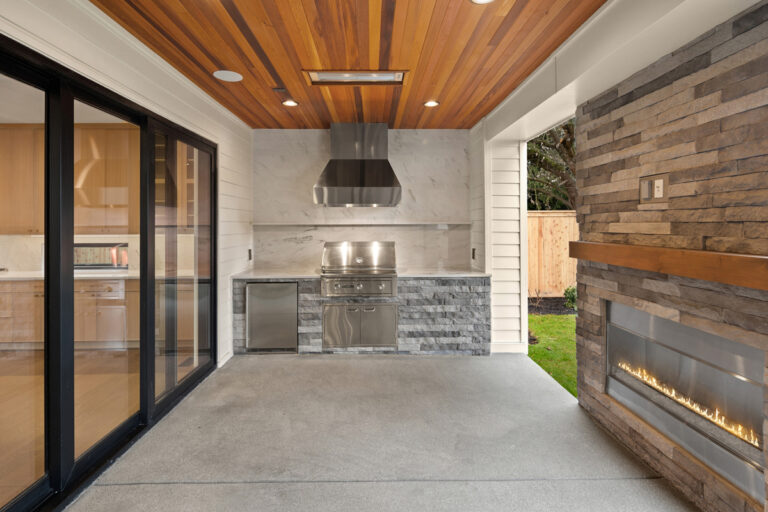 Brentwood custom floor plan covered patio with bbq and fireplace